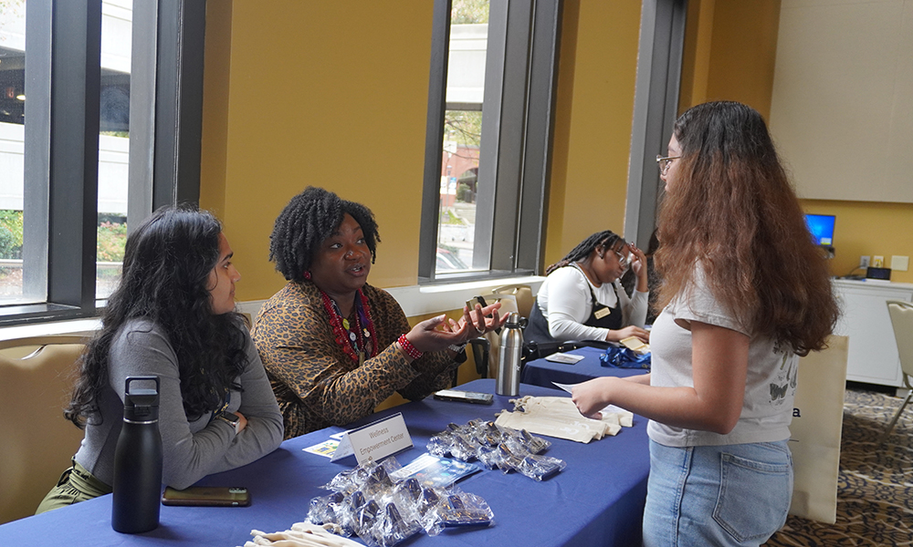 Students talk to staff at tabling for Georgia Tech First-Generation Symosium.