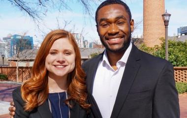 two students standing side-by-side