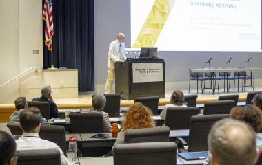 vice provost potts addresses crowd from podium